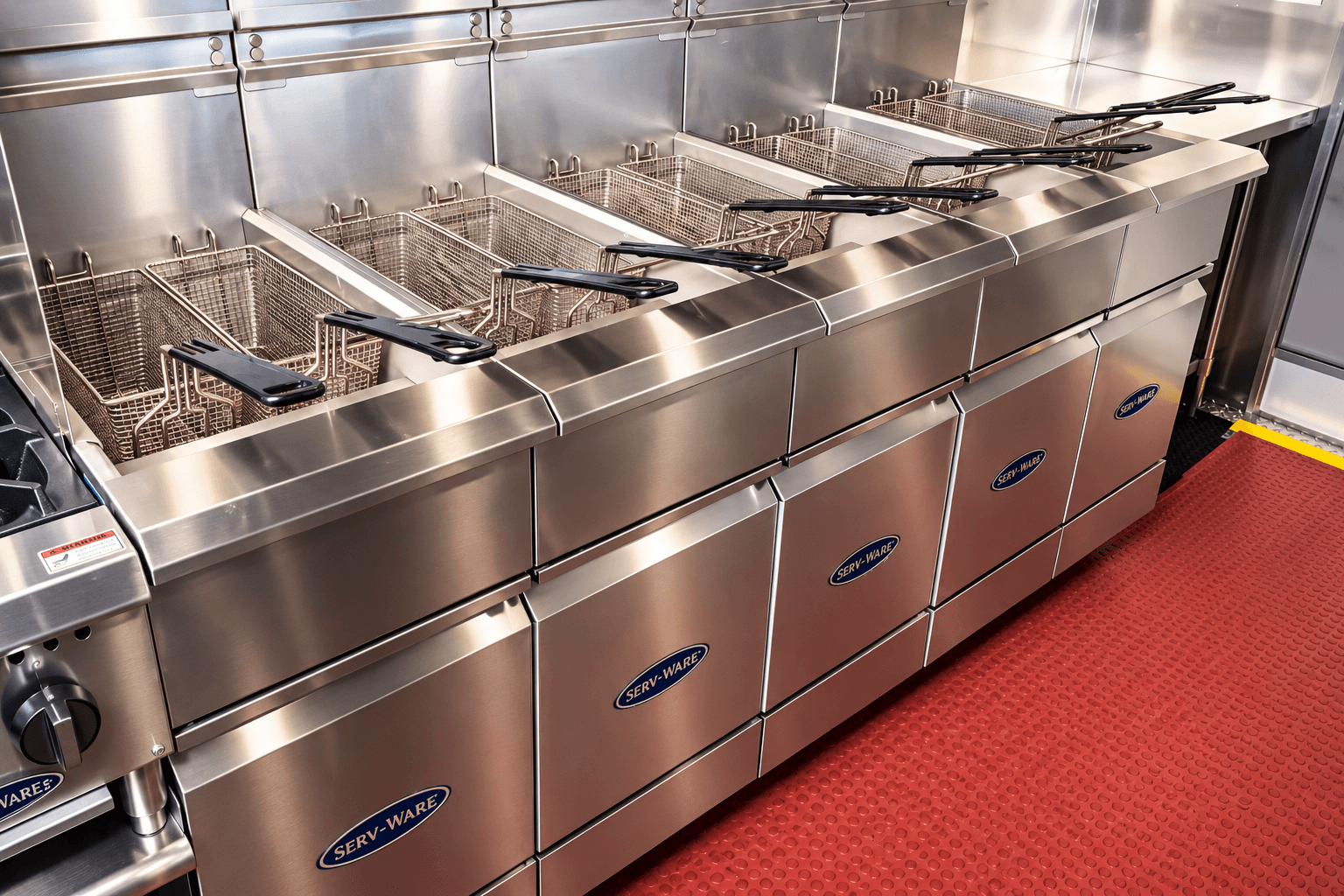 Commercial kitchen trailer equipment including a row of fryers